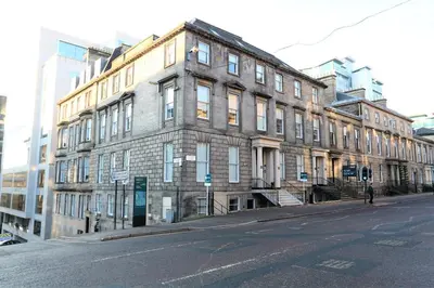 a large brick building on a city street at Dreamhouse Apartments Glasgow St Vincent Street in Glasgow