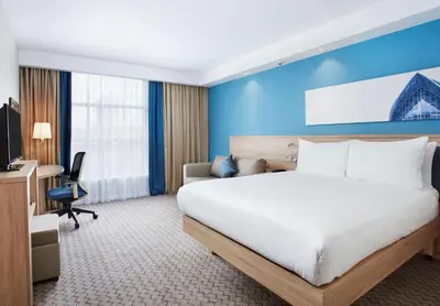 a hotel room with a bed and a desk at Hampton by Hilton Glasgow Central in Glasgow