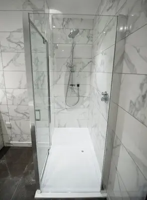 a shower with a glass door in a bathroom at Parklands Hotel & Country Club in Newton Mearns