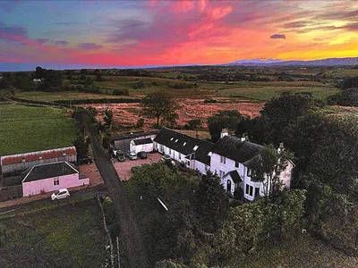 an aerial view of a house with a sunset at Fox House Thirdpart Farm in Beith