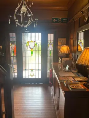 a room with stained glass windows and a desk at Fox House Thirdpart Farm in Beith