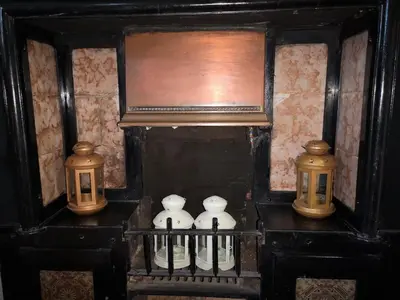 a group of vases and lights on a shelf at Heritage City - The Auld Pottery in Edinburgh