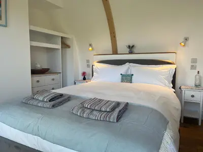 a bedroom with a bed with two pillows on it at Ceo Mara Croft b&b & 2 luxury Cabins in Taynuilt