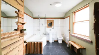 a bathroom with a tub and a toilet and a sink at The Inn at Kippen in Kippen