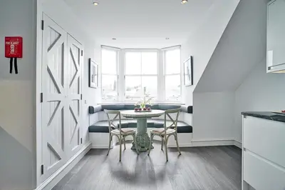 a dining room with a table and chairs at JOIVY Luxury Flats on George Street in Edinburgh