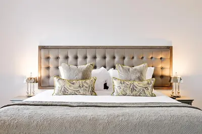 a bedroom with a large bed with pillows at JOIVY Luxury Flats on George Street in Edinburgh