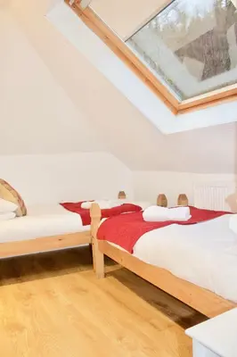 a bedroom with two beds and a skylight at The Boathouse in Glencoe