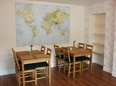 a room with two tables and a world map on the wall at Park View in Ballachulish