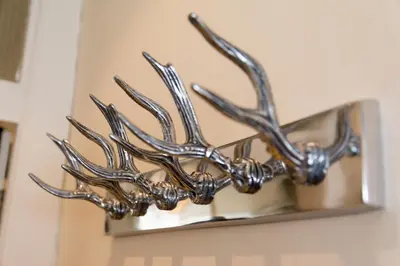 a metal reindeer antlers mounted on a wall at Luxury New Town 1 Bed Apartment in Edinburgh
