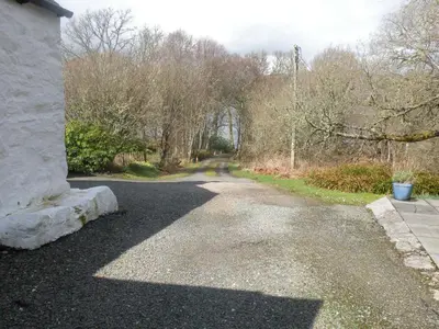 an empty road with trees on the side of a house at McHugh and Loudon Cottages in Saint Catherines