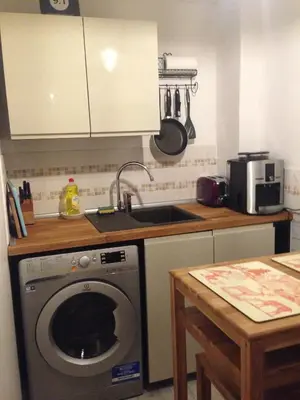 a kitchen with a washing machine and a sink at Castle view&Grassmarket studio flat with Luxury bathroom in Edinburgh