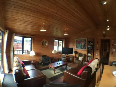 a living room with two couches and a tv at Lochlomondlodge22 in Rowardennan