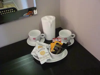 a table with two cups and some snacks on it at Riggend Farm Accomodation in Airdrie