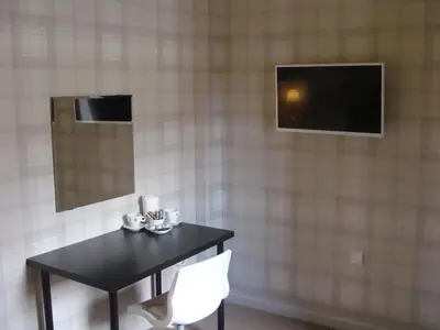a table and two chairs and a television in a room at Riggend Farm Accomodation in Airdrie