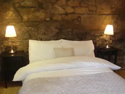 a bedroom with a bed with two lamps on tables at Riggend Farm Accomodation in Airdrie