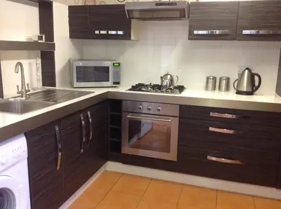 a kitchen with a sink and a stove top oven at The Guest Wing in Rothesay
