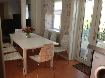 a dining room with a white table and chairs at The Guest Wing in Rothesay