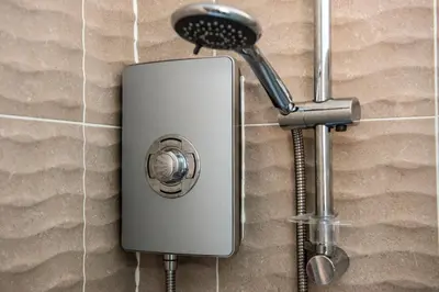 a shower head attached to a wall at No.17 Serviced Apartment in Glasgow
