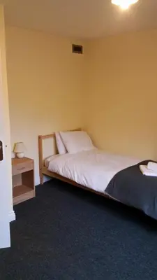 a bedroom with a bed and a nightstand and a bed sidx sidx sidx sidx at Livingston Ideal commuter House in Livingston
