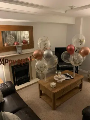 a living room with balloons and a coffee table at Katie's Flat in Oban