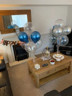 a living room with balloons and a coffee table at Katie's Flat in Oban
