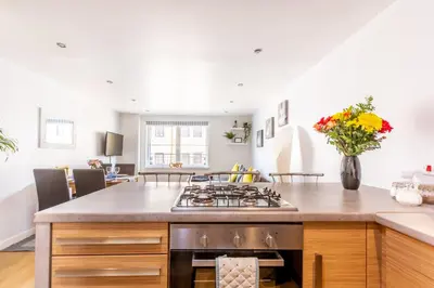 a kitchen with a stove and a counter top at Cosy Apartment in Quiet City-Centre with Car Park in Glasgow