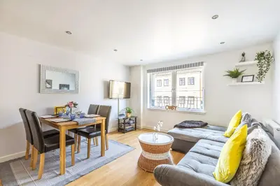 a living room with a couch and a table at Cosy Apartment in Quiet City-Centre with Car Park in Glasgow