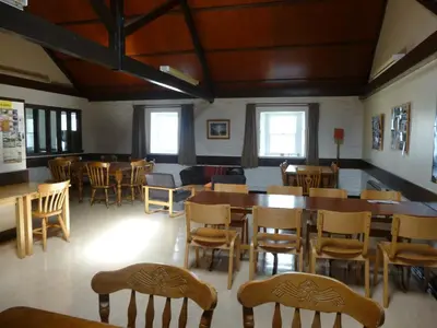 a dining room with wooden tables and chairs at Port Charlotte Youth Hostel in Port Charlotte