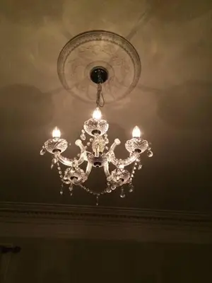 a chandelier hanging from a ceiling in a room at The Haven Cottage in Slamannan