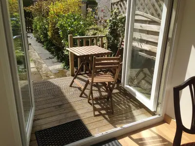 a table and two chairs on a porch at Charles's Street in Largs