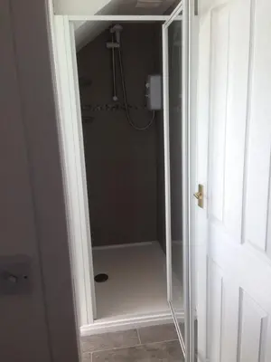 a shower with a glass door in a bathroom at Charles's Street in Largs