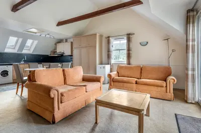a living room with two couches and a table at The Kenmore Club in Kenmore