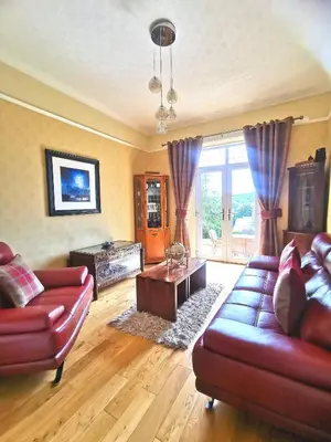 a living room with a couch and a table at The Knowe Guest House in Callander