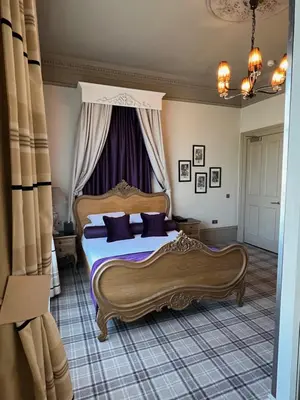 a bedroom with two beds and a window at Lynnhurst Hotel in Johnstone