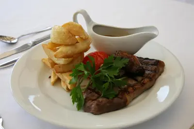 a plate of food with a steak and fries at BEST WESTERN The Crianlarich Hotel in Crianlarich