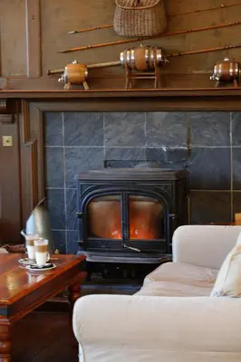 a fireplace in a living room with a stove at BEST WESTERN The Crianlarich Hotel in Crianlarich