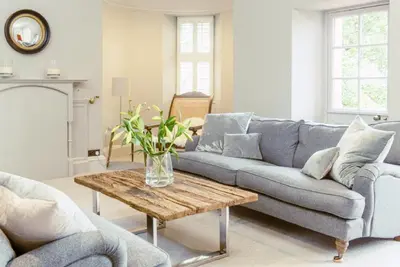 a living room with a couch and a table at Ramsay Gardens - Grand 4-Bedroom Apartment Next To Castle in Edinburgh