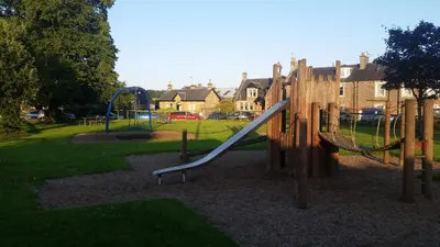 a playground with a slide in a park at Blair Drummond Holiday Home in Doune