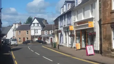 an empty street in a small town with buildings at Blair Drummond Holiday Home in Doune