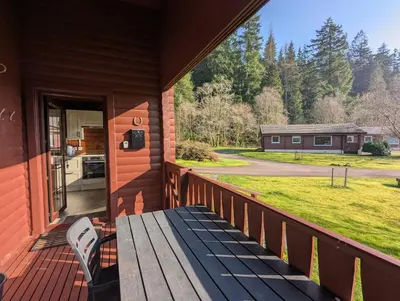 a porch of a house with a bench on it at Ruskin Lodges Argyll, by Puck's Glen, Rashfield near Dunoon in Dunoon