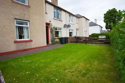 a yard in front of a house with a green lawn at Montgomery Apartments - Stevensons in Edinburgh