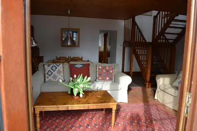 a living room with a couch and a coffee table at Oban Seil Farm in Clachan