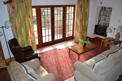 a living room with two couches and a tv at Oban Seil Farm in Clachan