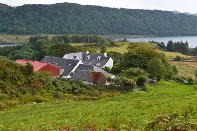 a house on a hill with a green field at Oban Seil Farm in Clachan
