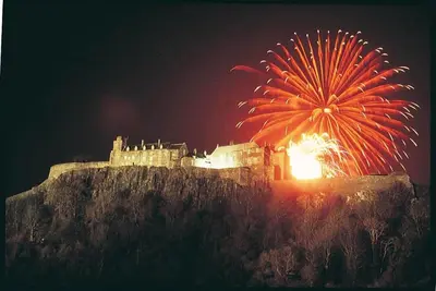 a fireworks display in front of a castle on a hill at Stirling Court Hotel in Stirling