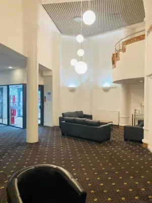 a lobby with couches and chairs in a building at Adamton Country House Hotel in Prestwick