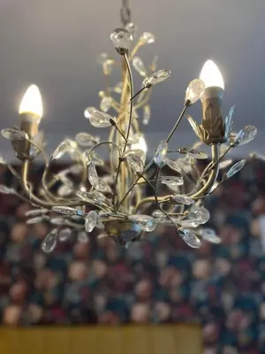 a chandelier with lights on top of a room at Rose Villa in Oban
