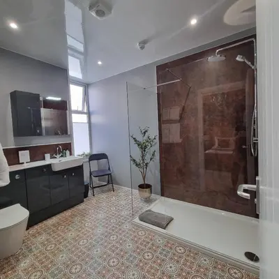 a bathroom with a shower and a toilet and a sink at Rose Villa in Oban