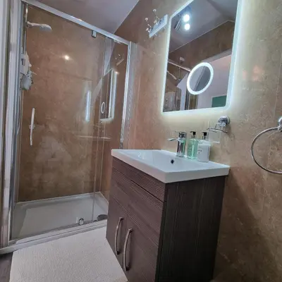 a bathroom with a sink and a shower at Rose Villa in Oban
