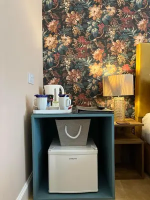 a blue cabinet with a table with a lamp on it at Rose Villa in Oban